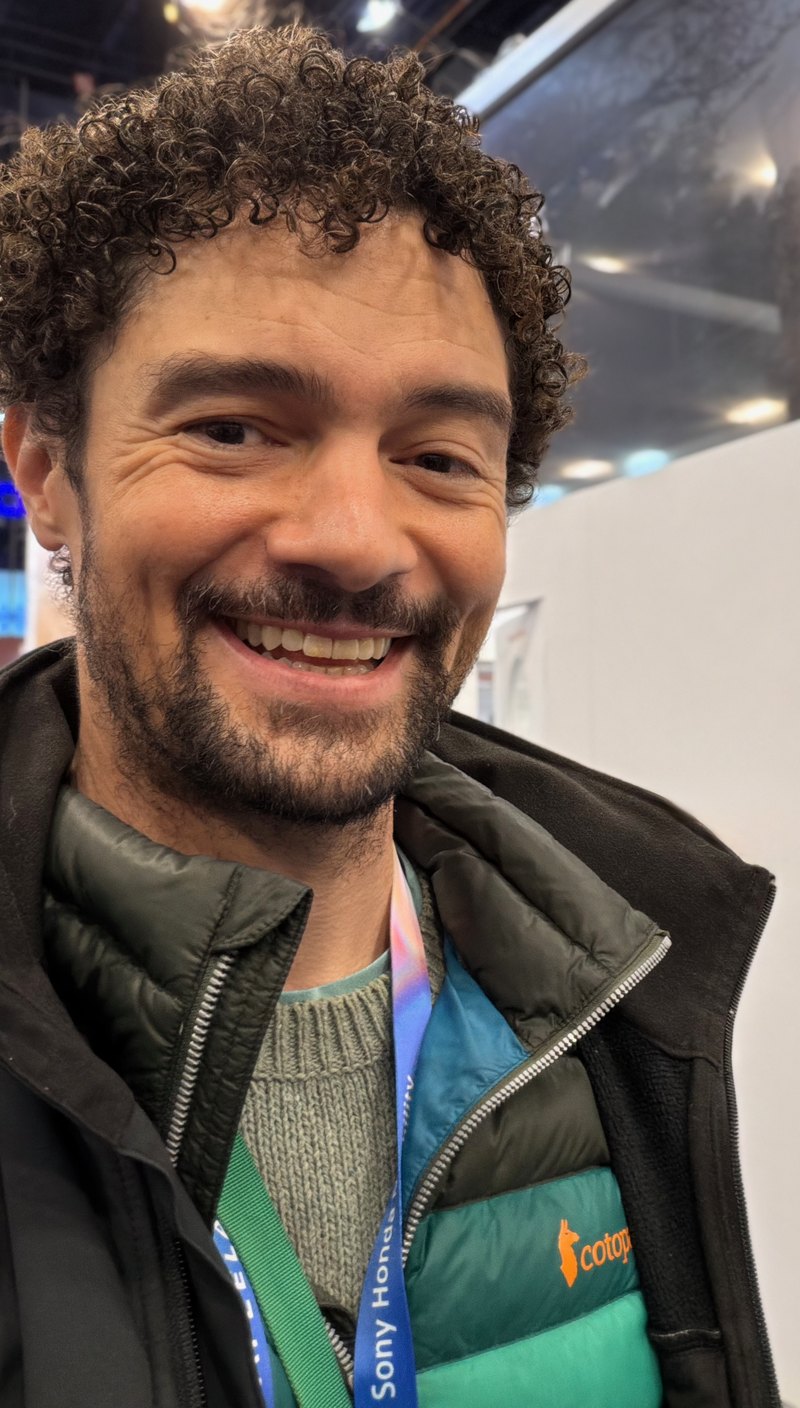 Ben Woo mid-laugh at a conference